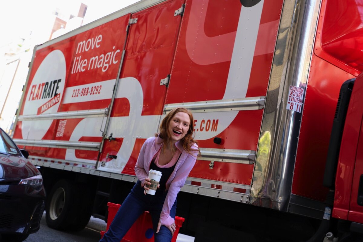 Woman standing next to a moving truck